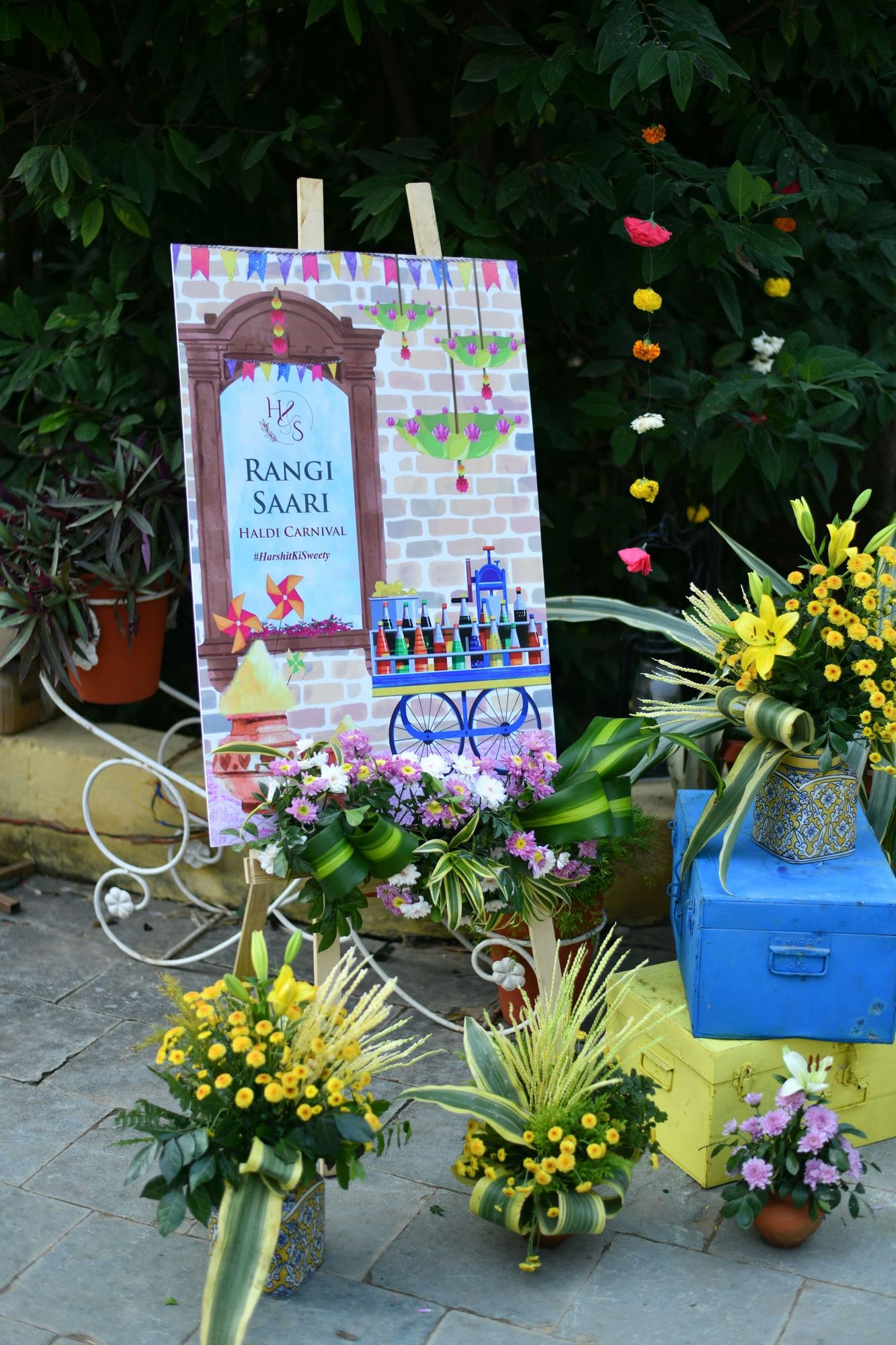 Hand-painted carnival signage and floral styling at a cultural celebration